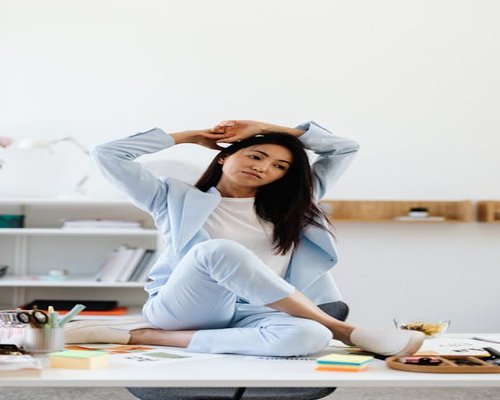 Person stretching gently near an office desk