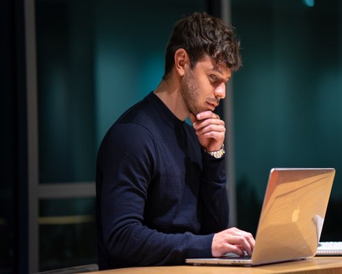 Person resting eyes from laptop screen